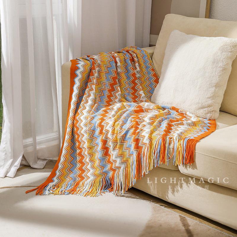 Retro bohemian-style knitted throw blanket with tassels.