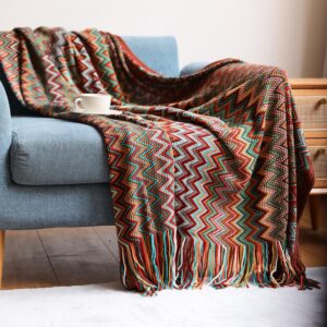Multi-colored, knitted, bohemian-style throw blanket with tassels
