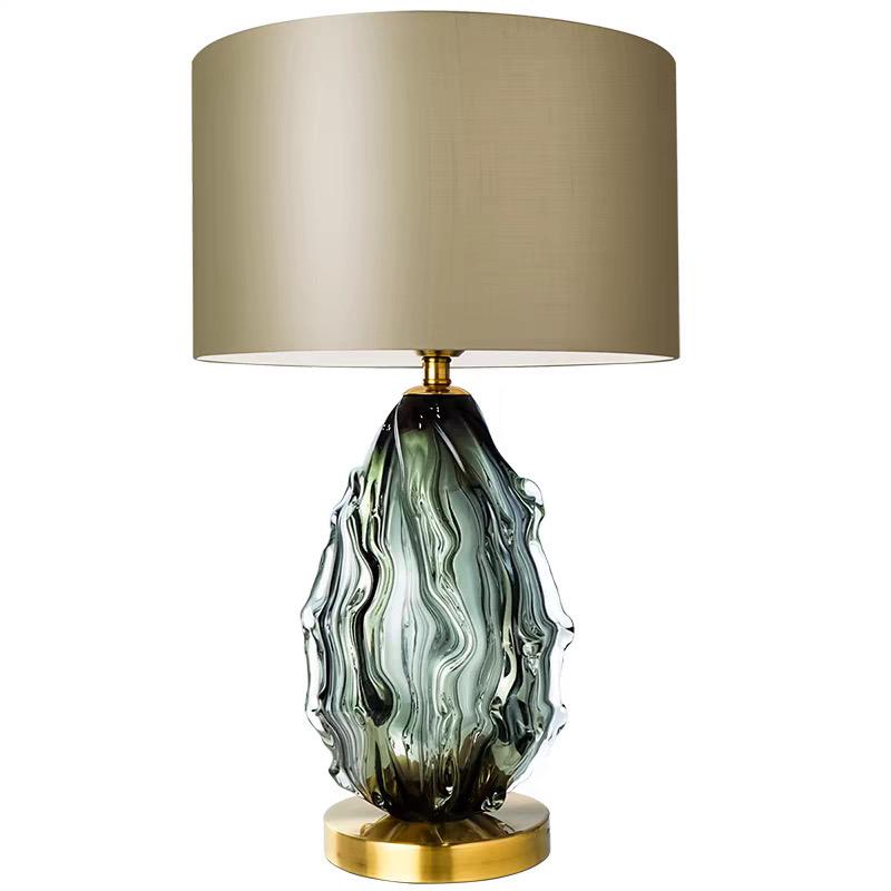 Modern green glass table lamp with a taupe fabric shade.