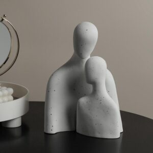 Abstract family-themed ceramic sculpture set in a speckled matte finish.