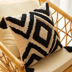 Black and white tufted geometric pillow cover with tassels.