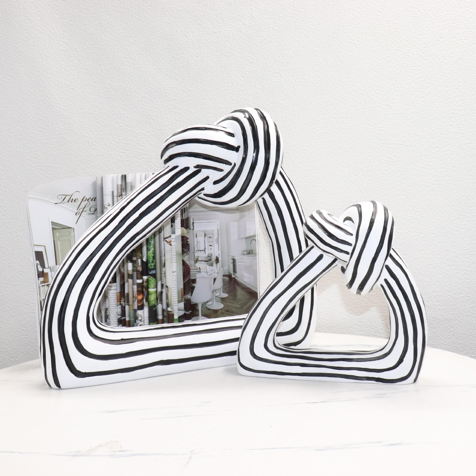 Black and white striped resin knot sculptures
